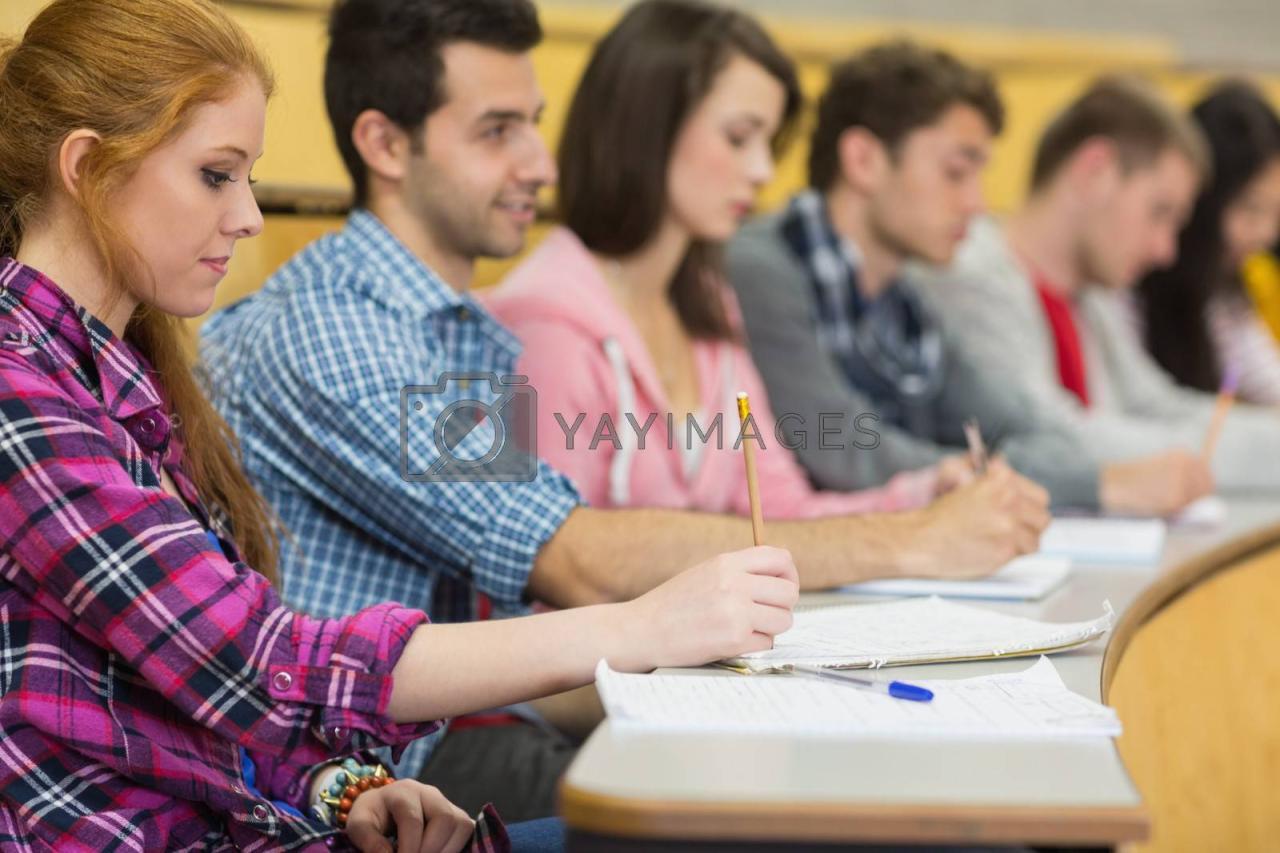 Row of students taking notes in a lecture hall Stock Photo - Alamy