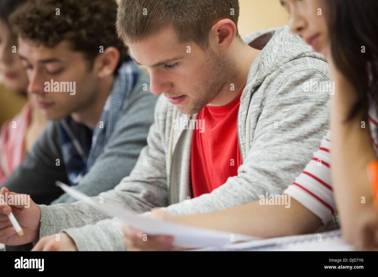 Female student taking notes in lecture hall Stock Photo - Alamy